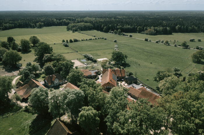 Eine Luftaufnahme vom Landhaus Averbeck mit vielen grünen Feldern.